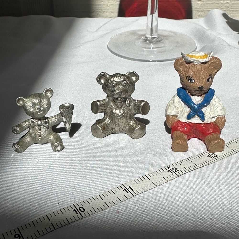 Three collectible tiny bear figurines